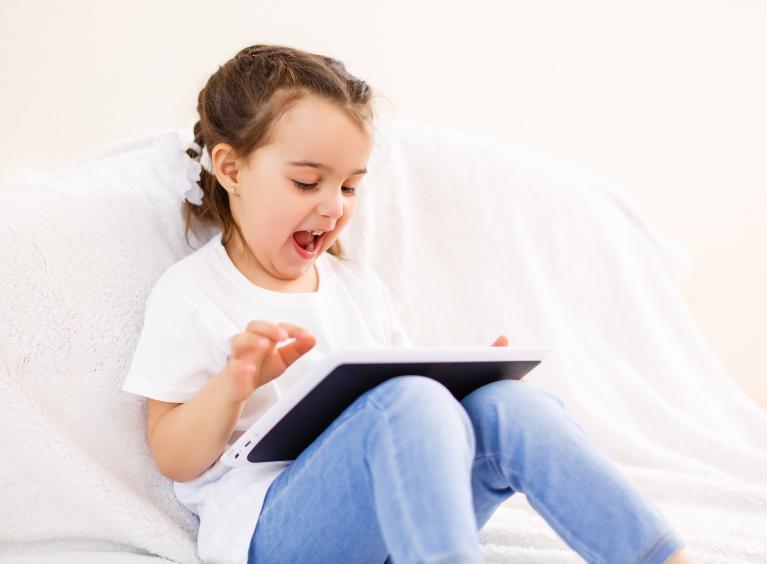 Young girl playing on iPad