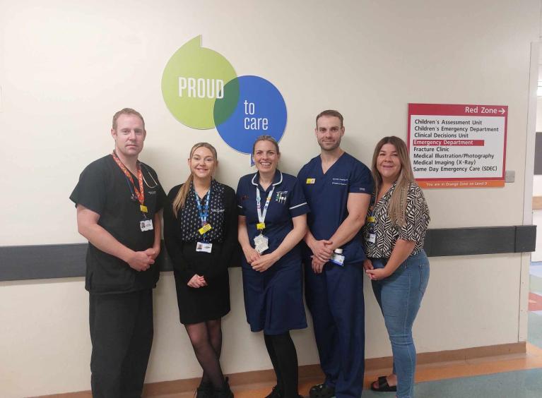 The five award hopefuls standing in front of the proud to care logo