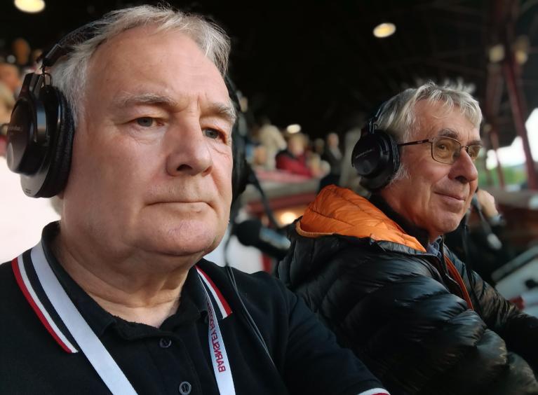 photo of Phil and colleague sat at the football match