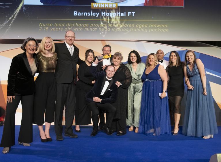 A [photo of the team being presented the award on stage