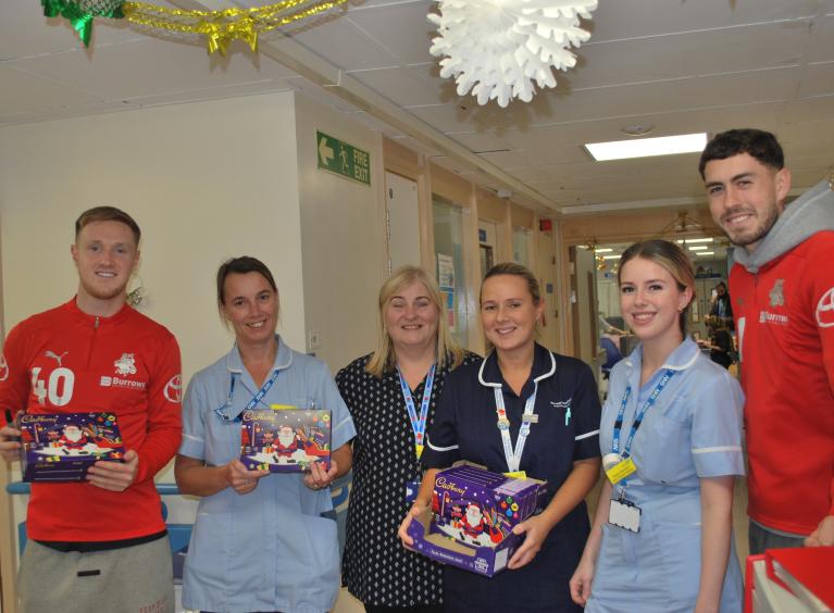 footballers with hospital staff