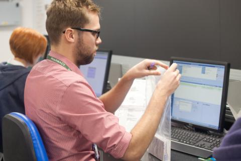 A person focuses intently as they complete an admin task