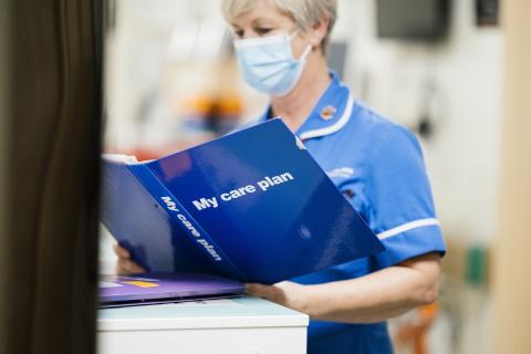 A nurse reads a care plan