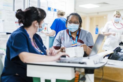 A student nurse talking with a colleague