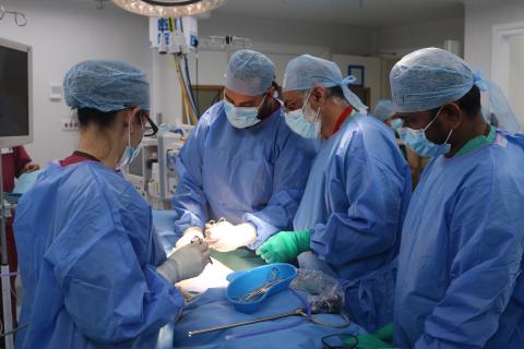 A team performs surgery