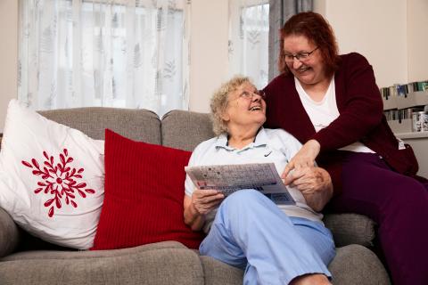 An older same-sex couple read together