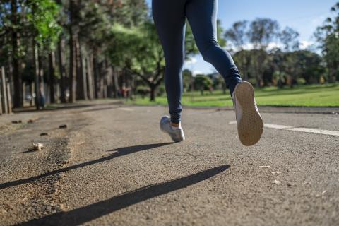 A woman runs through a park