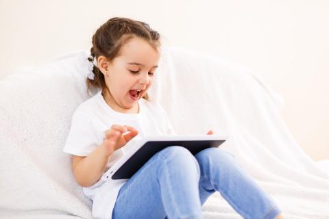 Young girl playing on iPad